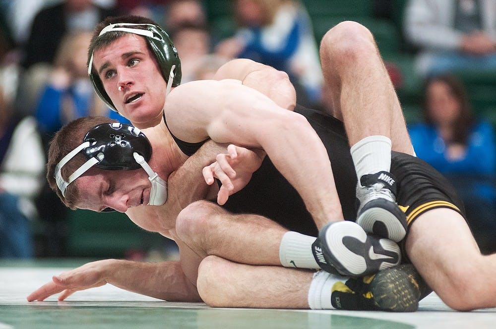 	<p>Senior 149-pounder Dan Osterman and Iowa&#8217;s Michael Kelly wrestle during a meet on Jan. 20, 2013, at Jenison Field House. Osterman won 10-4. Julia Nagy/The State News</p>