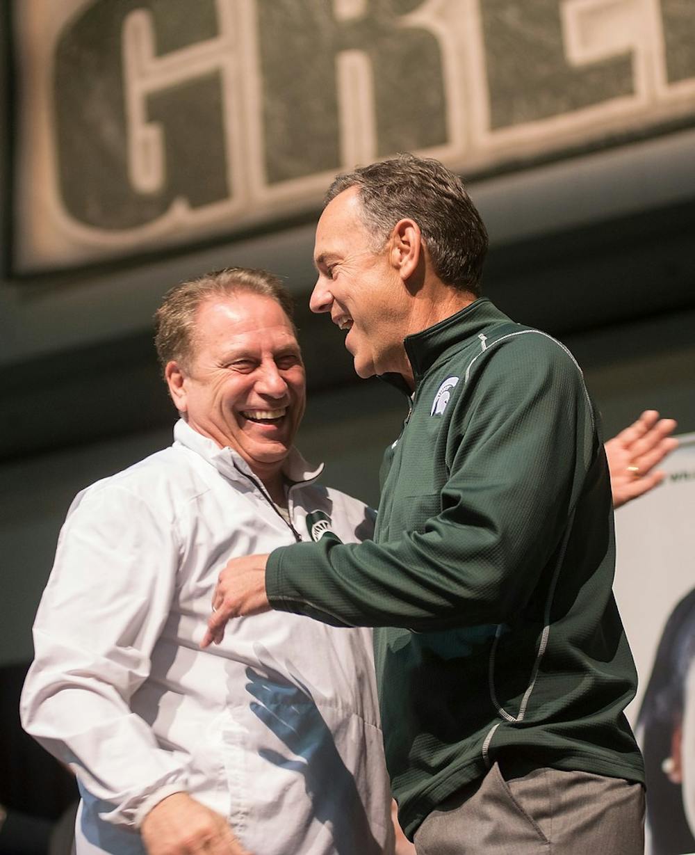 <p>Football head coach Mark Dantonio welcomes Men's basketball head coach Tom Izzo to the stage April 3, 2015, during a final four Spartan pep rally at the Indiana Convention Center , 100 S. Capitol Ave., in Indianapolis, Indiana. Erin Hampton/The State News</p>
