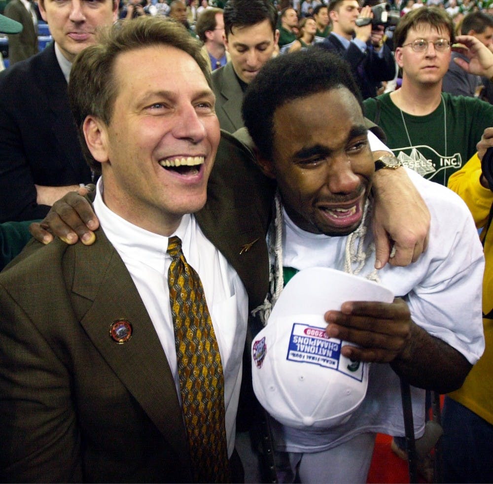 <p>Michigan State coach Tom Izzo and guard Mateen Cleaves hug as they watch a video during the Spartans victory celebration at the RCA Dome in Indianapolis. The Spartans beat the Florida Gators, 89-76, to win the NCAA national championship.</p>
