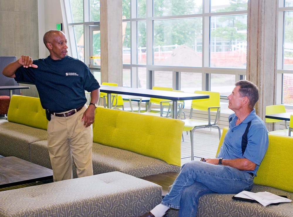 	<p>Assistant vice president for the Division of Residential and Hospitality Services Vennie Gore, left, and <span class="caps">MSU</span>&#8217;s construction representative Ken Dawson, right,  discuss major benefits of recent Emmons Hall renovations on Thursday afternoon. Gore noted the use of glass walls and large windows as a means of reducing energy by taking advantage of natural lighting. </p>