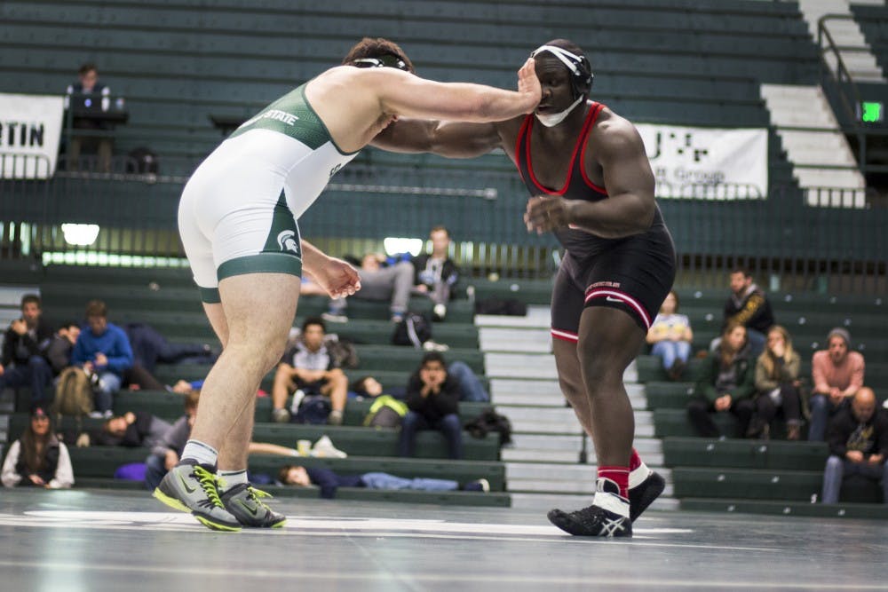 Sophomore 285-pounder Jacob Cooper grapples with Rutgers 285-Pounder Razohnn Gross on Jan. 29, 2017 at Jenison Field House. The Spartan wrestlers were defeated by the Scarlet Knights, 12-24.