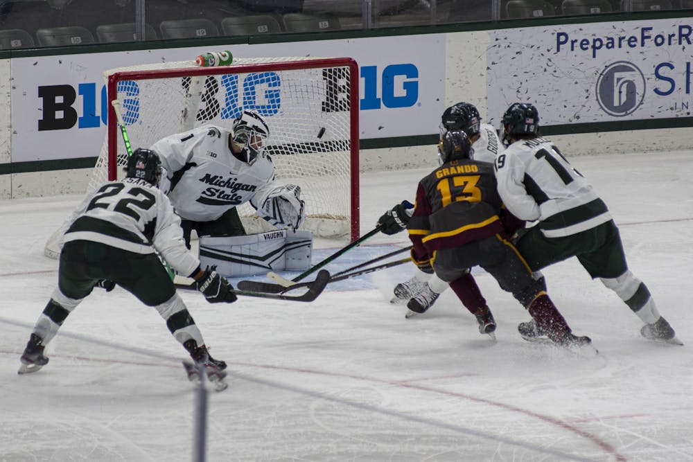 <p>Arizona State forward Chris Grando (13) scores past MSU goaltender Drew DeRidder (1) to tie up the game in the third period. The Spartans tied 1-1 with the Sun Devils after four periods Nov. 19, 2020.</p>