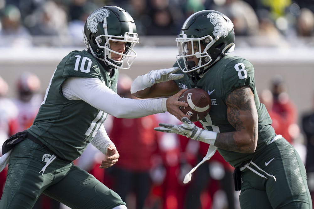 Redshirt junior quarterback Payton Thorne, 10, passes the ball to redshirt sophomore running back Jalen Berger, 8, during Michigan State’s last game at home against Indiana on Saturday, Nov. 19, 2022 at Spartan Stadium. Indiana ultimately beat the Spartans, 39-31.