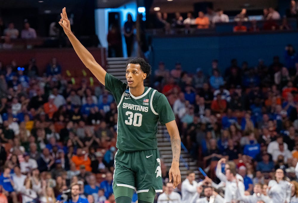 Marcus Bingham Jr. (30) holds up three fingers in celebration of a three-pointer during Duke's victory over Michigan State on March 20, 2022.