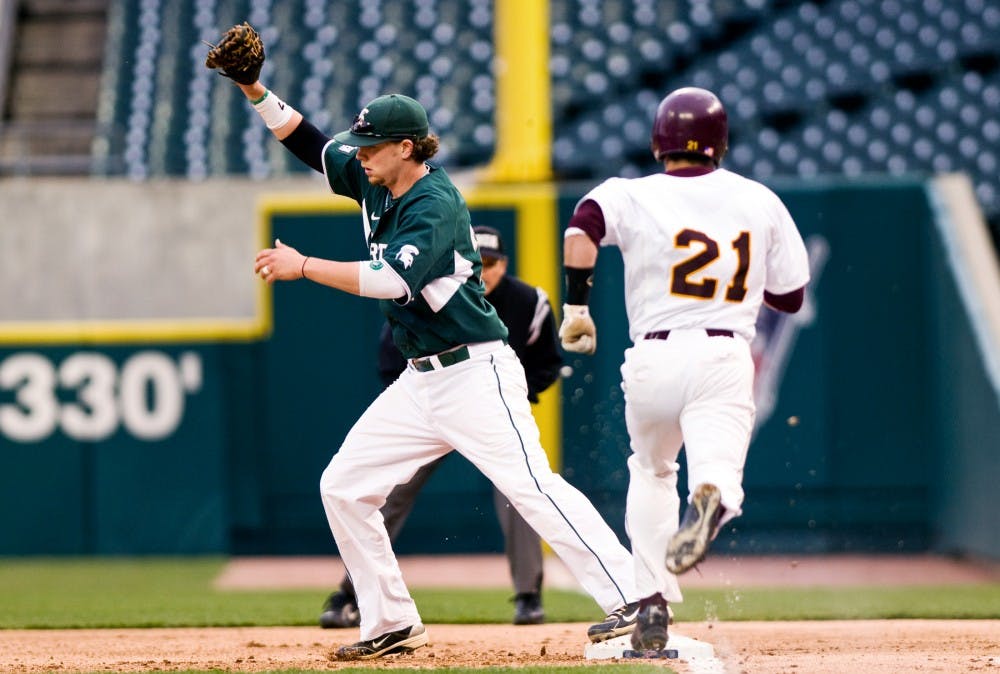 	<p>Senior first baseman Jeff Holm catches a throw before Central Michigan third baseman Tyler Hall can reach the bag Wednesday at Comerica Park in Detroit. The Spartans defeated the Chippewas 3-1 in the Clash at Comerica. Matt Radick/The State News</p>