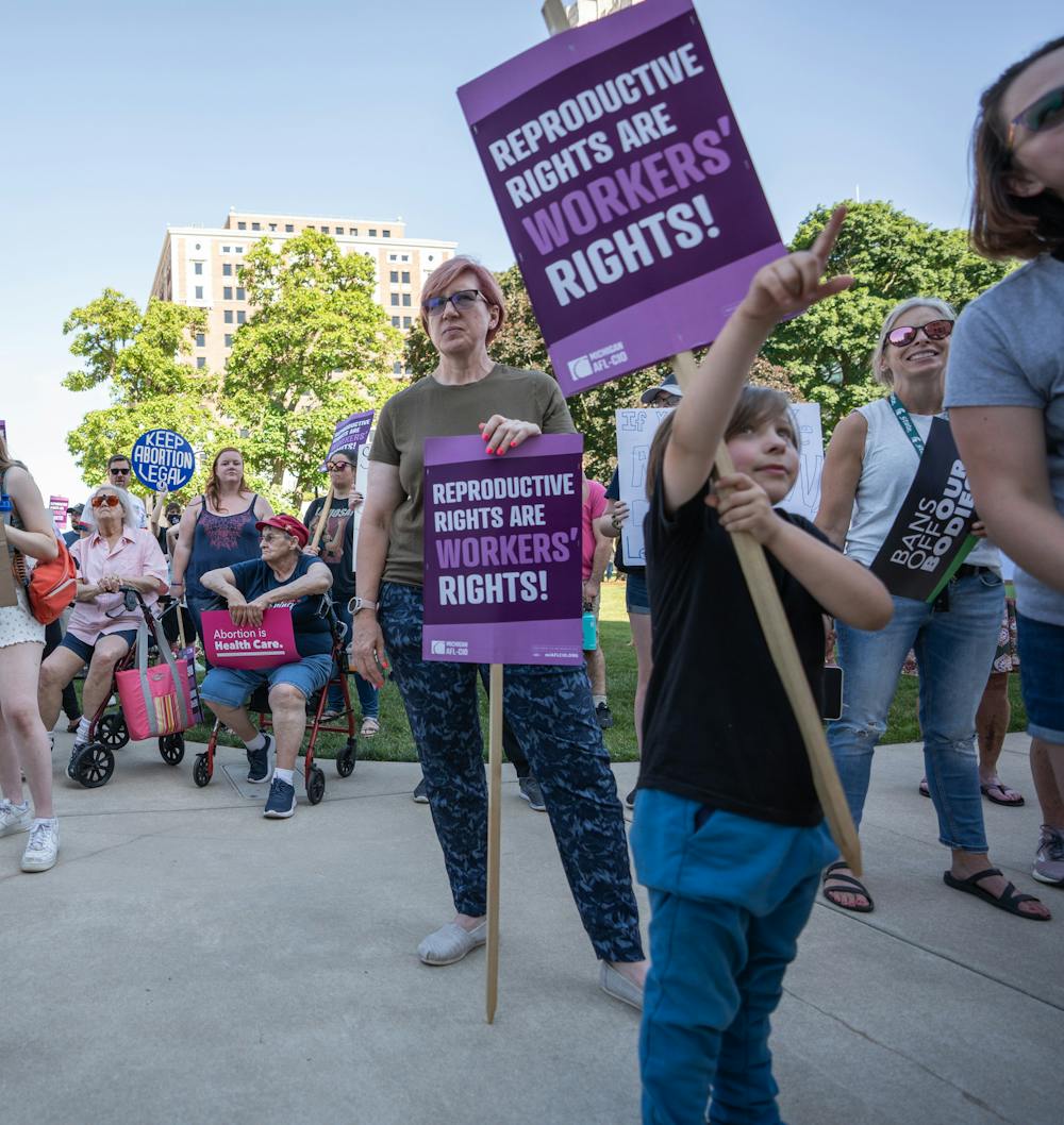<p>Abortion-rights protesters stand in front of the Michigan State Capitol on June 24, 2022. Protesters gathered after the Supreme Court overturned the constitutional right to an abortion, decided by Roe v. Wade in 1973, through their decision in the Dobbs vs. Jackson WOmen&#x27;s Health Organization case.</p>