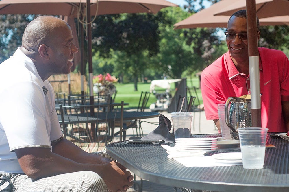 <p>Former MSU teammates Earvin "Magic" Johnson and Greg Kelser chat at the Detroit Golf Club in Detroit on August 11, 2015 during the MSU Black Alumni Association Golf Classic. Joshua Abraham/The State News</p>