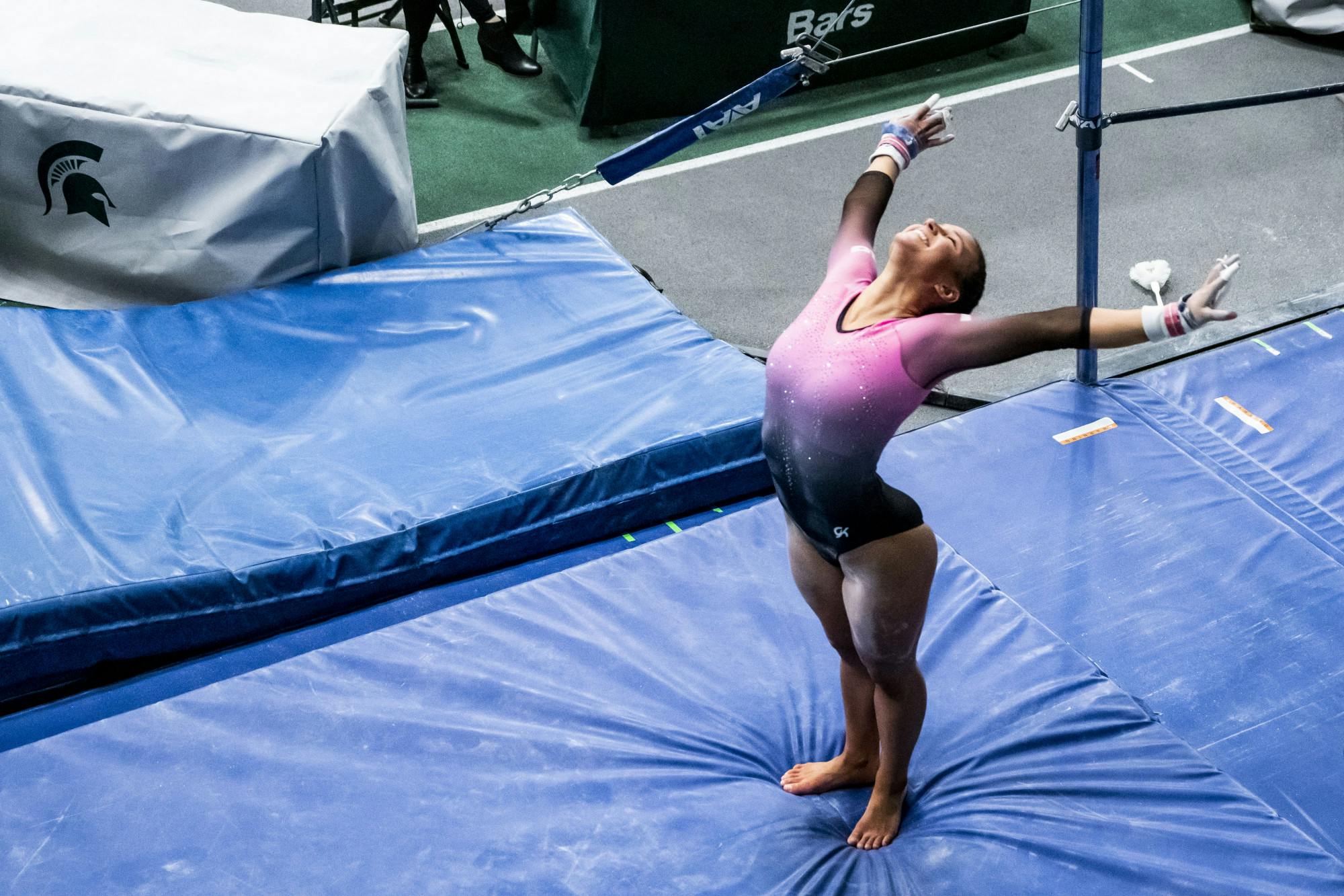 Freshman Delanie Harkness lands after coming off the bars at MSU's tri-meet against Ohio State and Nebraska on January 30, 2021 at the Jenison Fieldhouse. The Spartans took a win with 195.775 points.