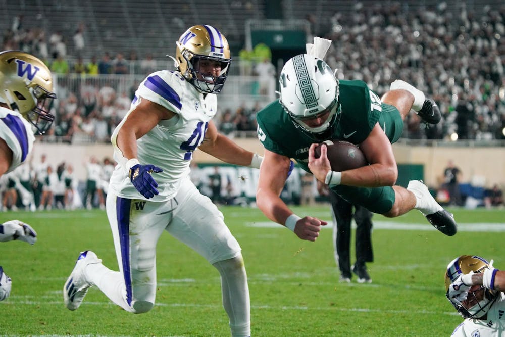 <p>Redshirt freshman quarterback Katin Houser (12) diving for a touchdown during the game against University of Washington at Spartan Stadium on Sept. 16, 2023. The Spartans would go on to lose the game 41-7.</p>