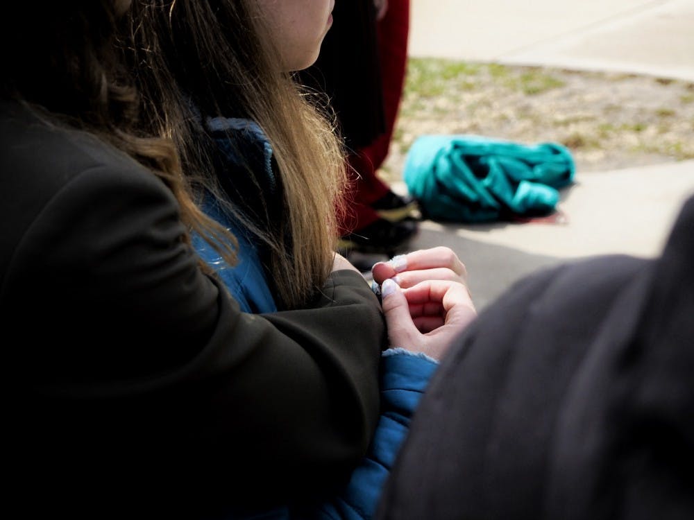 <p>Survivors Amanda Cosman and Mimi Wegener hug during the Survivor Tree Dedication Ceremony east of the MSU Museum on April 16, 2019. The tree planting ceremony was held to honor survivors and family members affected by sexual violence.          </p>