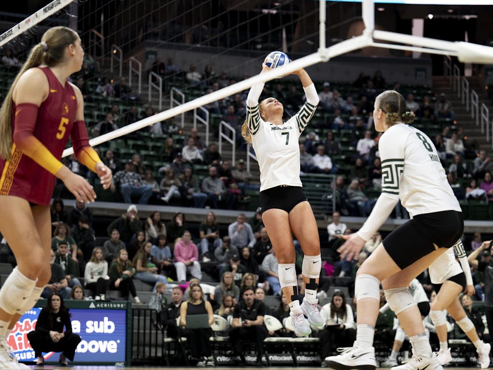 Michigan State redshirt–freshman setter Malayah Long (7) sets the ball for sophomore middle blocker Mia Hood (8) to spike during the volleyball game against USC at the Breslin Center on Wednesday, Nov. 26, 2025.