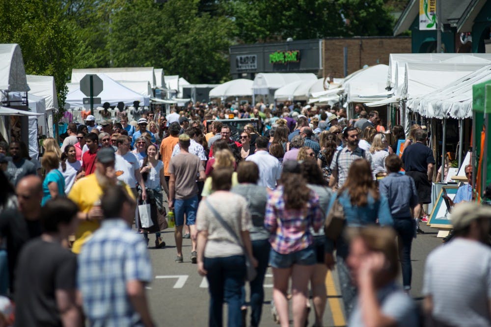 Festivalgoers roam around Albert Ave. during the 53rd annual East Lansing Art Festival on May 22, 2016 in East Lansing. The East Lansing Art Festival is ranked 50th in the nation in the Top 100 Fine Art Festival List by Sunshine Artist Magazine.