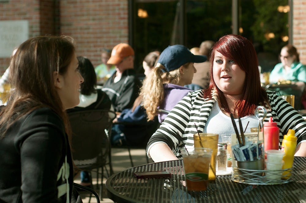 	<p>Alumnae Stacey Mitchell, left and Nichol Lavire have a drink at the The Peanut Barrel Restaurant, 521 E. Grand River Ave. May 25, 2013. The Peanut Barrel Restaurant has outdoor dining during the summer months. Weston Brooks/The State News</p>