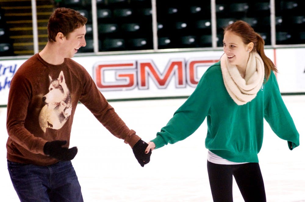 Finance senior Max Wellinger ice skates with social science education senior Kelsey Loomis Friday at Munn Ice Arena. Open skate at Munn is one of the many winter activities you can enjoy right on campus. Derek Berggren/The State News