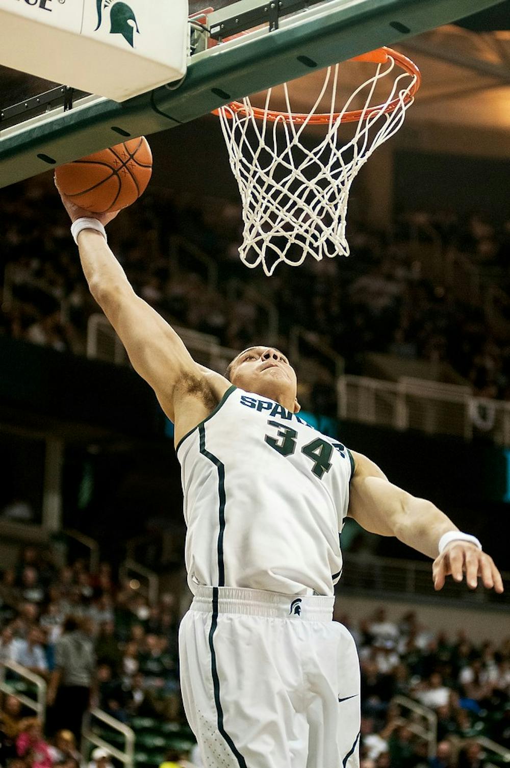 	<p>Freshman forward Gavin Schilling grabs a rebound to dunk the ball during the game against Indiana University of Pennsylvania, Nov. 4, 2013, at Breslin Center. The Spartans are leading at halftime, 47-26. Danyelle Morrow/The State News</p>