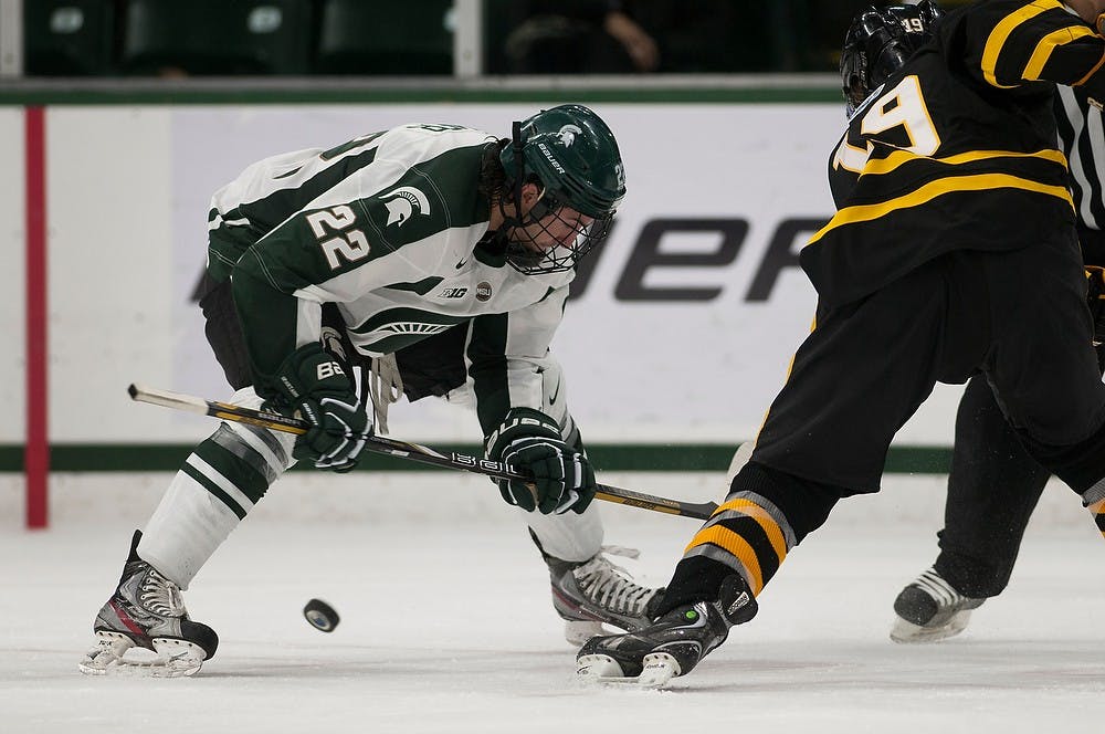 	<p>Senior forward Lee Reimer wins a face off against American International forward  Blake Peake on Nov. 1, 2013, at Munn Ice Arena. The Spartans beat the Yellow Jackets, 5-4. Danyelle Morrow/The State News</p>