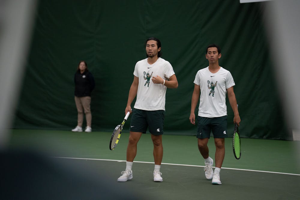 <p>Senior Kazuki Matsuno and sophomore Josh Portnoy wait for a serve during their doubles match against Michigan at the MSU Tennis Center on March 30, 2023. The Spartans lost to the Wolverines 6-1.</p>