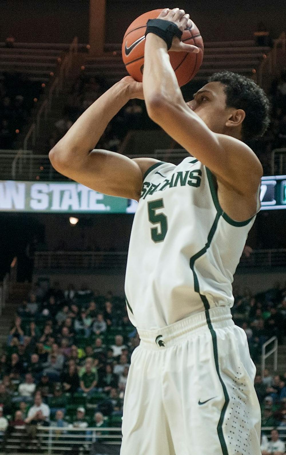 <p>Junior guard Bryn Forbes goes up for a point during the game against Arkansas-Pine Bluff on Dec. 6, 2014, at the Spartan Stadium. The Spartans defeated the Golden Lions, 85-52. Aerika Williams/The State News </p>