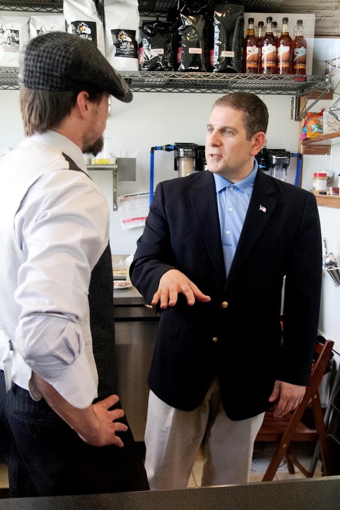 Lansing Mayor Virg Bernero talks to store owner John Miller of Artie's Filling Station on Tuesday afternoon May 15, 2012. Artie's Filling Station is a walk-up and drive-thru coffee shop that is located at 127 W. Grand River Ave. Natalie Kolb/The State News