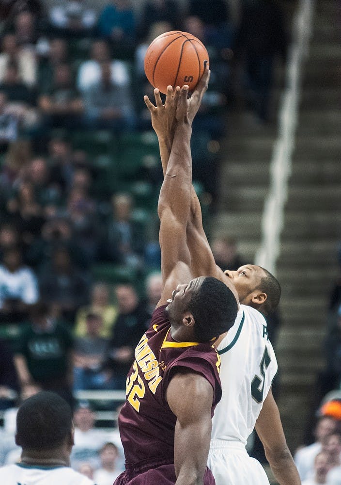 	<p>Junior center Adreian Payne battles Minnesota forward Trevor Mbakwe during the opening tip-off of the game Wednesday, Feb. 6, 2013, at Breslin Center. The Spartans defeated the Golden Gophers, 61-50, improving their record to 8-2 in the Big Ten. Adam Toolin/The State News</p>