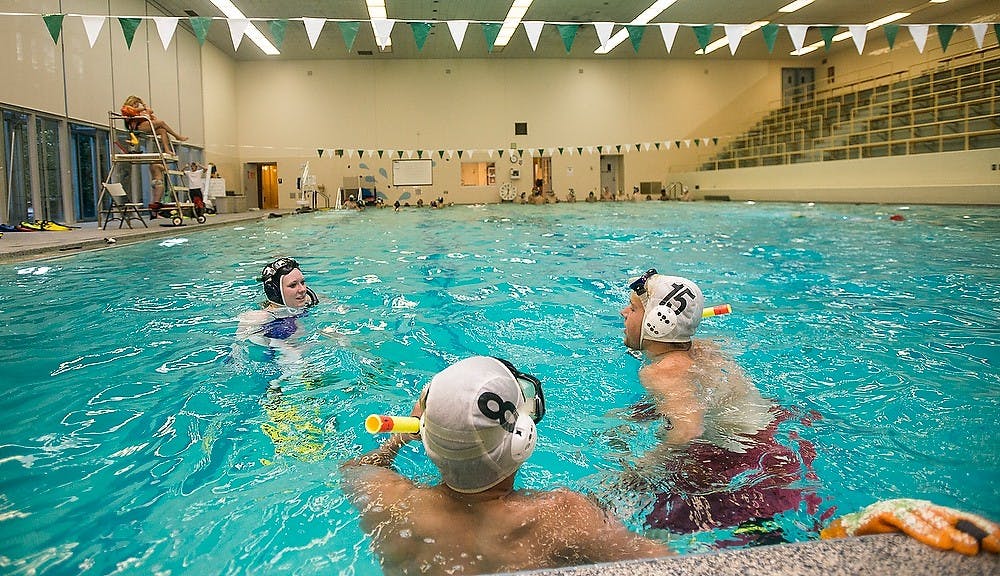 <p>Marketing senior and MSU Underwater Hockey president Colleen Anthony talks about the game to potential players  Sept. 9, 2014, during underwater hockey practice in IM Sports-Circle on W Circle Drive. MSU Underwater Hockey is open to anyone who wants to play for as long as the season is open. Erin Hampton/The State News </p>