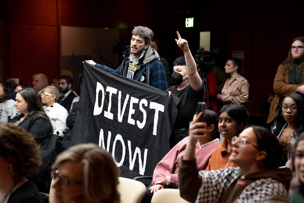 Attendees of a Board of Trustee's meeting call for the university's divestment from Israel in East Lansing, Mich., Feb. 2, 2024. The Board of Trustees fielded comments from the public, including the divestment of the university's assets from Israel.