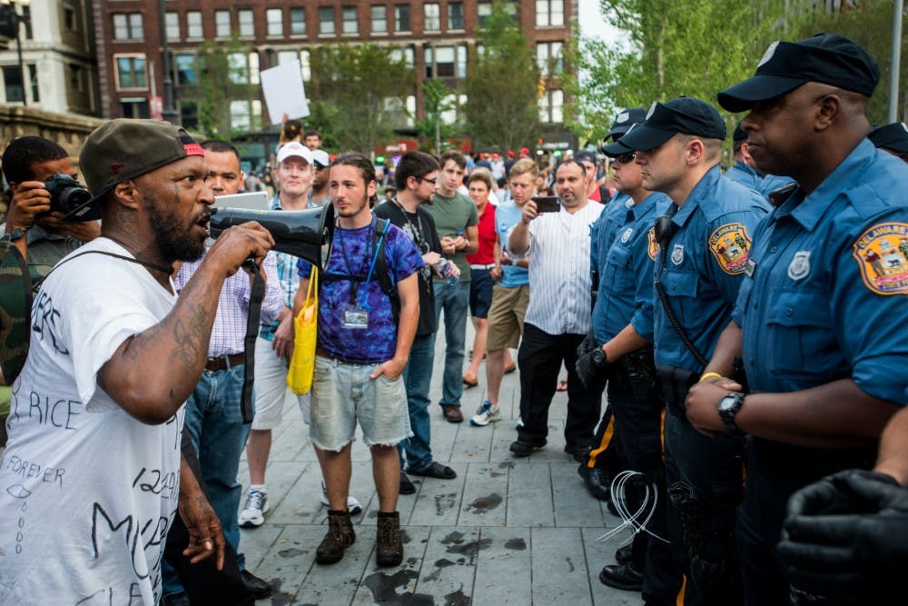 A man yells at police officers on July 21, 2016, the last day of the Republican National Convention, at Public Square in Cleveland, Ohio. 