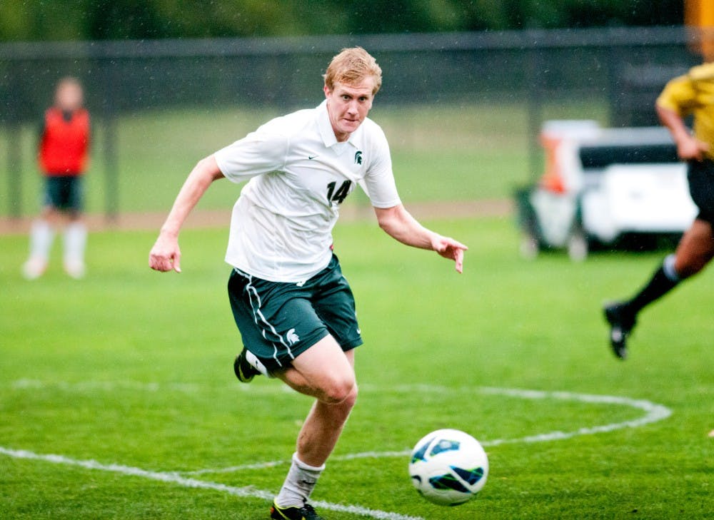 Senior midfielder Luke Norman fights to save the ball from going out of bounds on Friday, Sept. 21, 2012 at DeMartin stadium. Norman contributed one of two goals in the Spartan's 2-1 victory over Western Michigan.