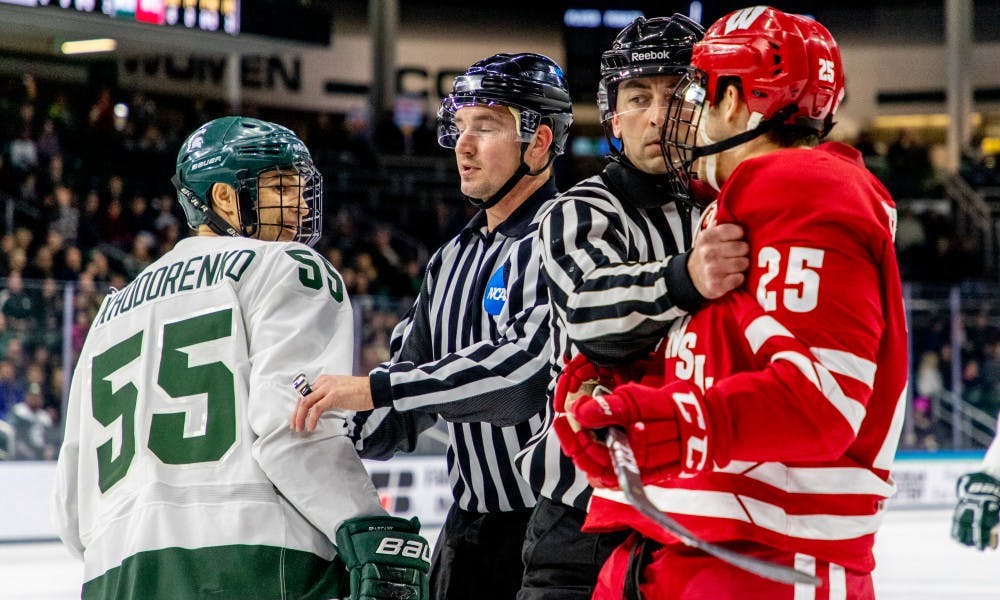 Junior center Patrick Khodorenko (55) smirks at a Wisconsin player after some extra-curricular activity during the game against Wisconsin on Feb. 2, 2019. The Spartans trail the Badgers 1-0 at the end of the first period.