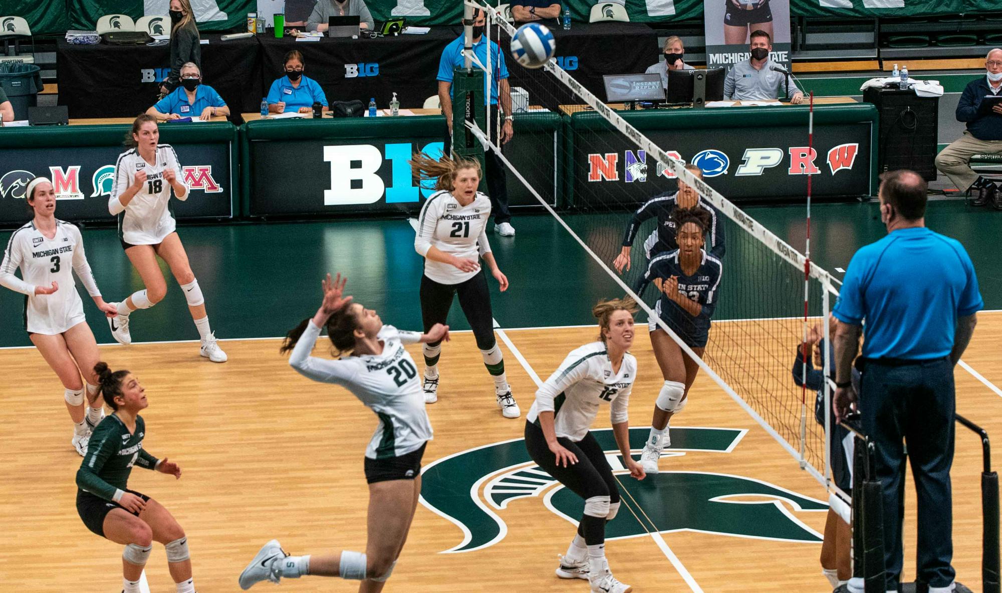 <p>Sophomore outside hitter Cecilee Max-Brown (20) jumps to kill the ball as the rest of the stadium watches. The Nittany Lions shut out the Spartans, 3-0, on March 20, 2021. </p>