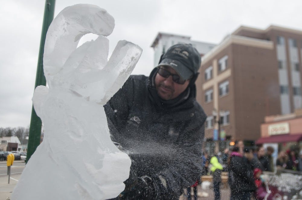 Ice sculptor Scott Miller works on a piece during Winter Glow on Dec. 3, 2016 at Ann St. Plaza.  In addition to live sculpting, the event featured horse and carriage rides, live music and booths from different local businesses. 