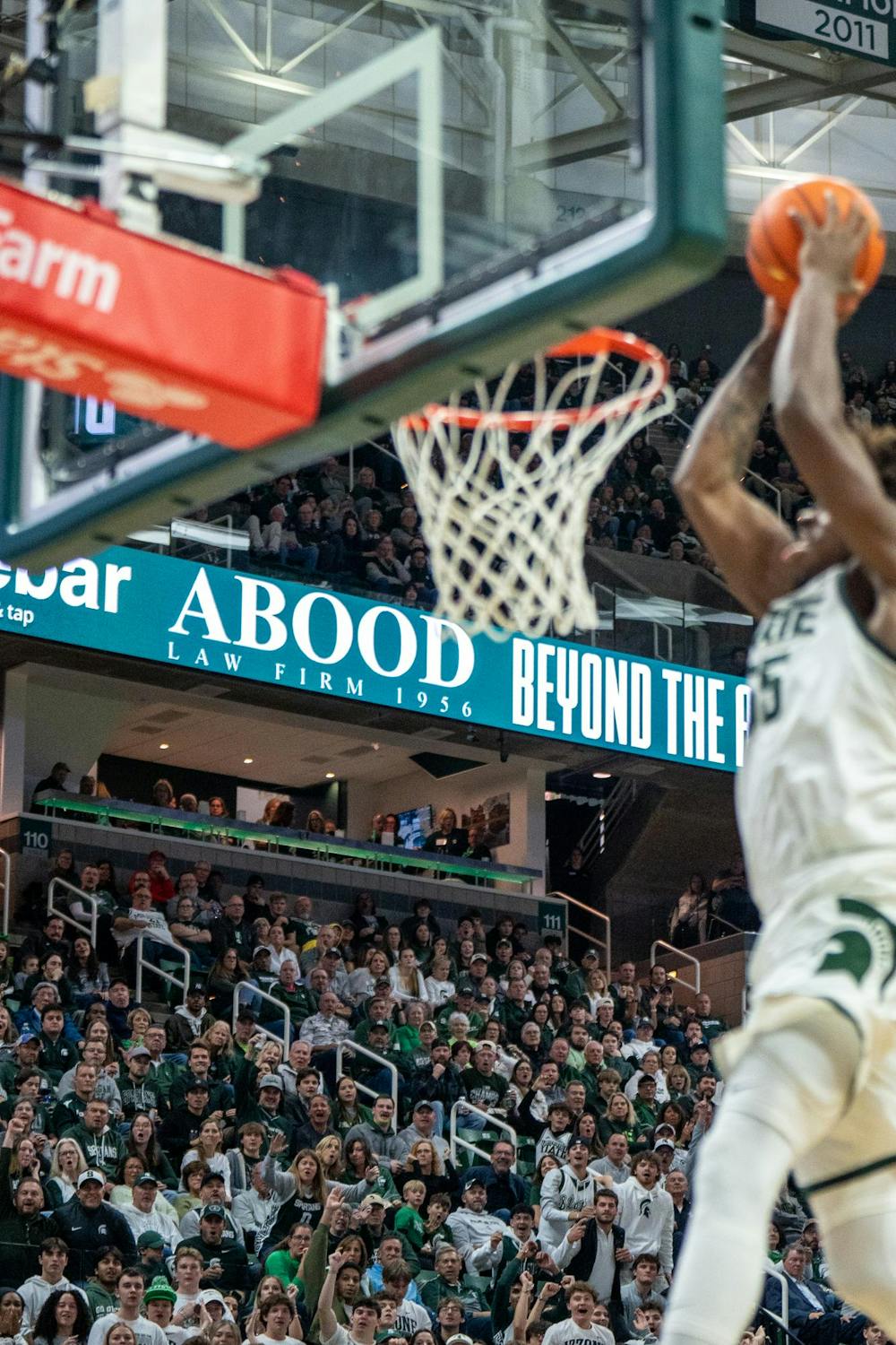 The crowd prepares to erupt as Michigan State forward Coen Carr (55) dunks the ball during MSU’s game against Detroit Mercy at Breslin Center in East Lansing, Mich., on Friday, Nov. 21, 2025.