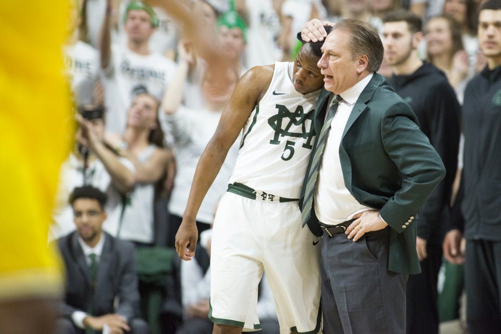 Freshman guard Cassius Winston (5) and head coach Tom Izzo embrace during the first half of the men's basketball game against the University of Michigan on Jan. 29, 2017 at Breslin Center. The Spartans defeated the Wolverines, 70-62.