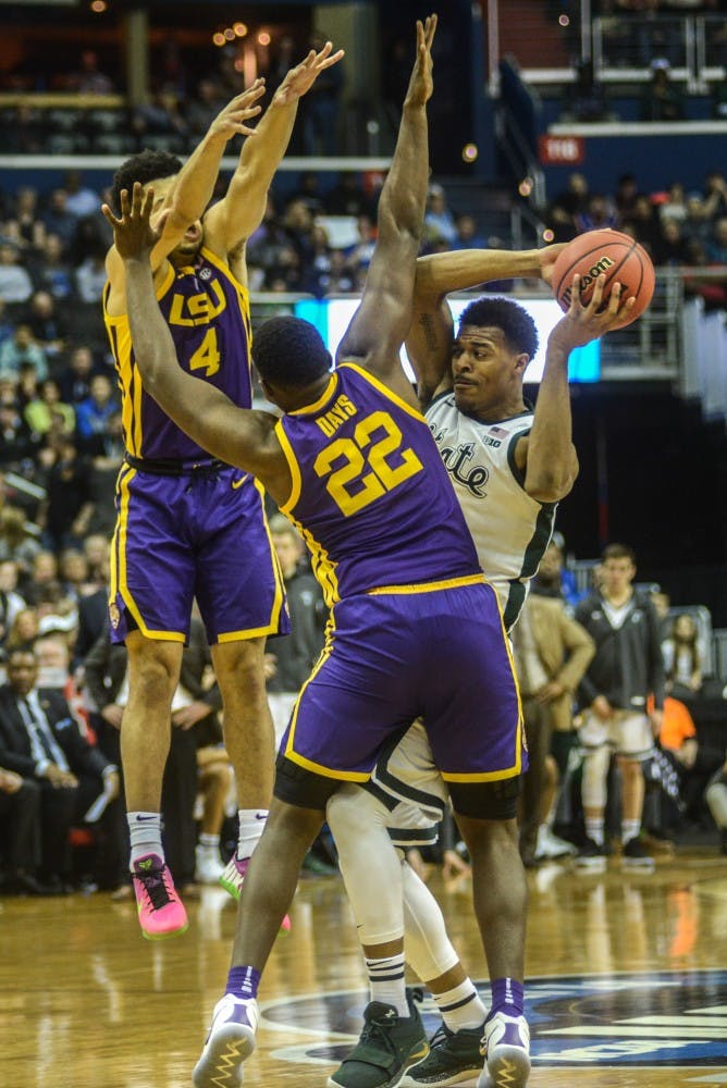 Sophomore forward Xavier Tillman (23) defends the ball against LSU’s forward Darius Days (22) and guard Skylar Mays (4) during the game against LSU at Capital One Arena on March 29, 2019. The Spartans defeated the Tigers, 80-63.