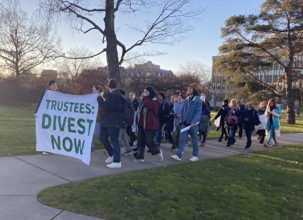 Students march from the Hannah Administration Building, protesting MSU's investment in Israeli aid on Friday, Dec. 15, 2023.