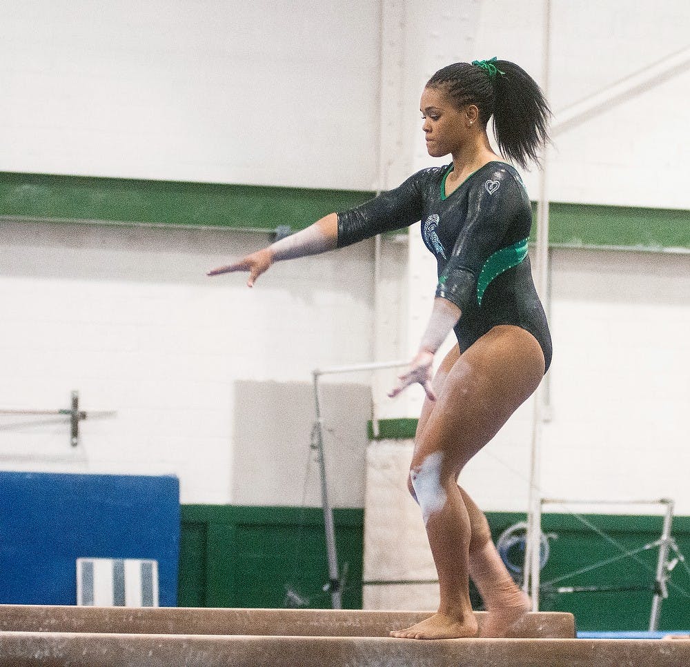 	<p>Sophomore Alina Cartwright performs her balance beam routine at the annual Green and White scrimmage on Sunday, Dec. 2, 2012 at Jenison Field House. In a close finish, the White team fell to the Green squad 115.65-115.50. Katie Stiefel/ State News</p>