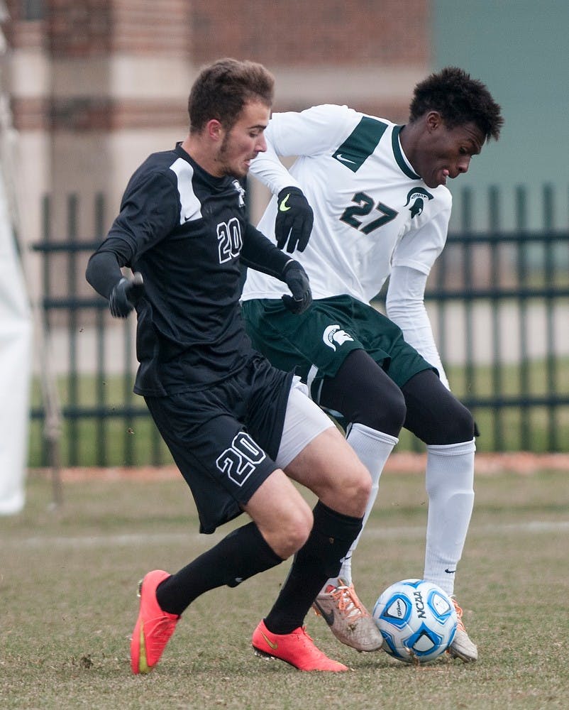 <p>Senior midfielder Fatai Alashe fights for the ball against Providence College midfielder Daniel Neust