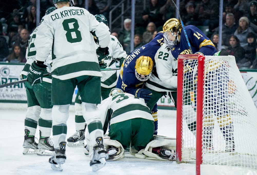 <p>Graduate student goalie Dylan St. Cyr (37) scrambles to make a save during a game against Notre Dame at Munn Ice Arena on Feb. 3, 2023. The Spartans defeated the Fighting Irish 3-0.</p>