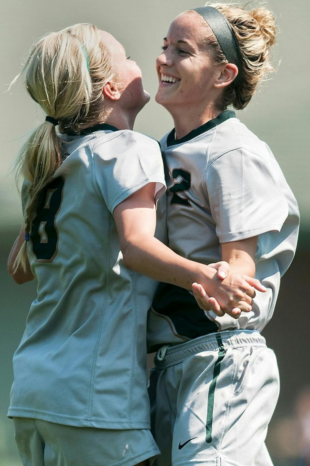 	<p>Redshirt freshman midfielder Jessica White, 8, celebrates with sophomore forward Allyson Krause, 2, after a goal is scored during the game against Milwaukee, Aug. 25, 2013, at DeMartin Soccer Stadium. The Spartans defeated Milwaukee, 5-2. Danyelle Morrow/The State News</p>