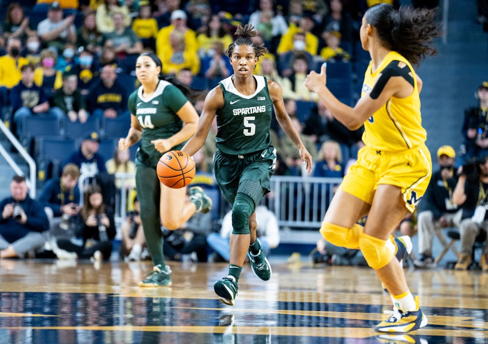 <p>Graduate student guard Kamaria McDaniel (5) dribbles the ball during the game against Michigan at the Crisler Center on Jan. 14, 2023. The Spartans lost to the Wolverines 70-55.</p>