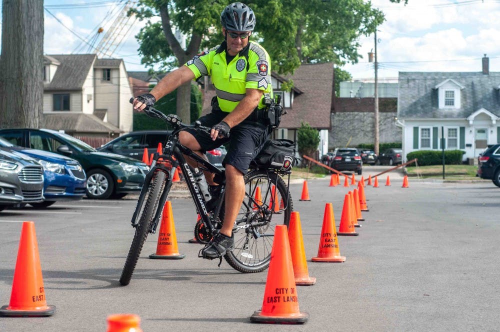 Bike Officer Chad Pride practices his skills at the East Lansing Police Department Open House on July 26, 2018.