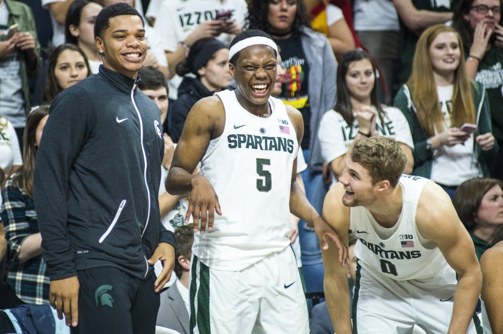 Freshman guard Miles Bridges (22), freshman guard Cassius Winston (5) and sophomore guard Kyle Ahrens (0) celebrate during the second half of the men's basketball game against Youngstown State on Dec. 6, 2016 at Breslin Center. The Spartans defeated the Penguins, 77-57.