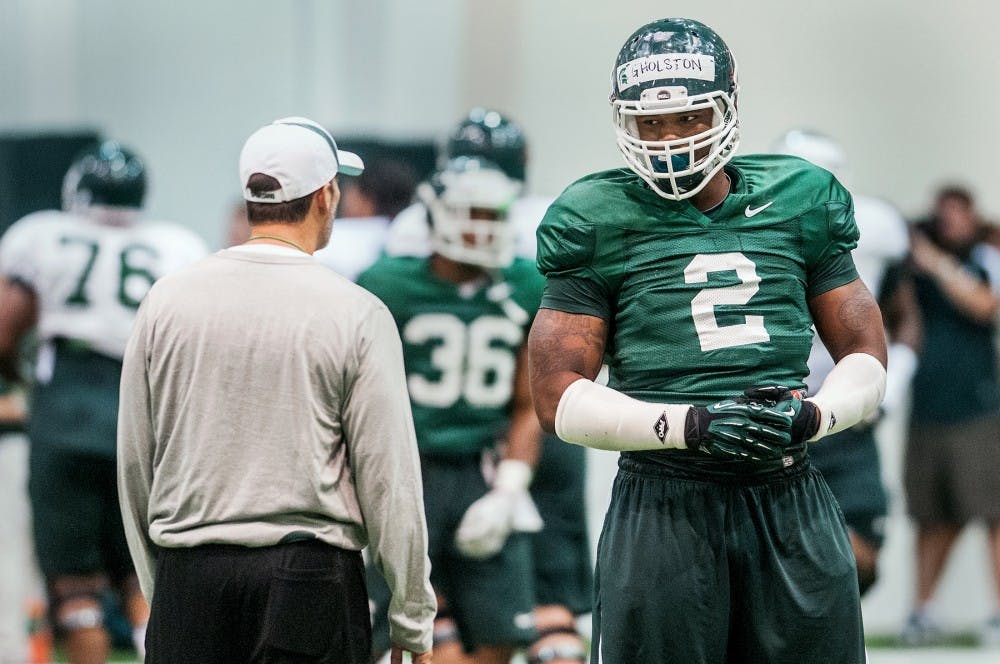 Junior defensive end William Gholston chats with running backs/recruiting coordinator, Brad Salem Monday evening, Aug. 13, 2012 at the Duffy Daugherty Football Building. The Spartan football team is gearing up for the 2012 season, opening Aug. 31 with a home game against Boise State. Adam Toolin/The State News