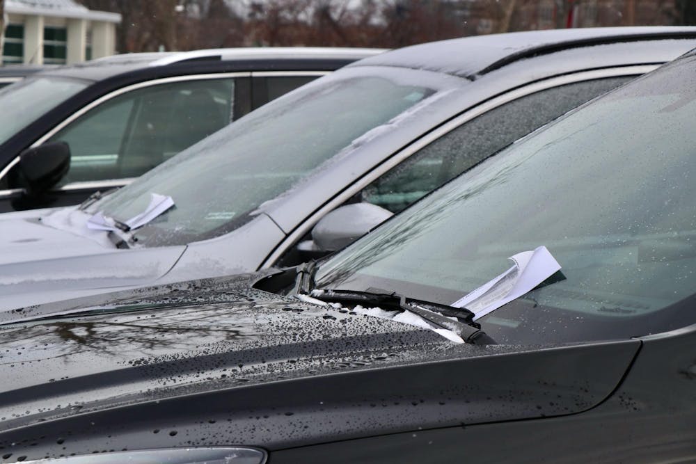 <p>Tickets wave underneath the windshield wipers of several cars parked at Erickson Hall on the morning of Jan. 18, 2023. </p>
