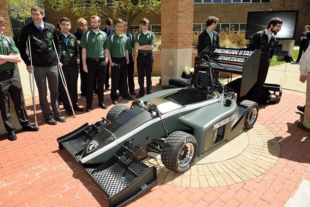 <p>The Formula SAE team is pictured here with the vehicle they designed. Photo courtesy of the Formula SAE team.</p>
