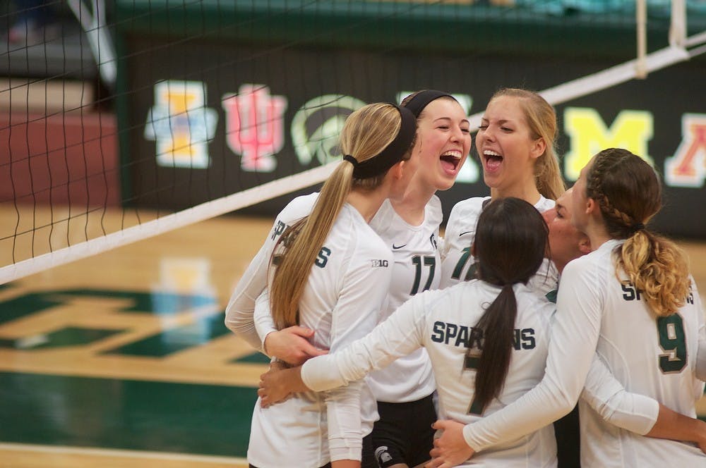 <p>The MSU volleyball team cheers after a huddle Nov. 26, 2014 during the game against Purdue at Jenison Field House. MSU defeated the Boilermakers, 3-0. Dylan Vowell/The State News</p>