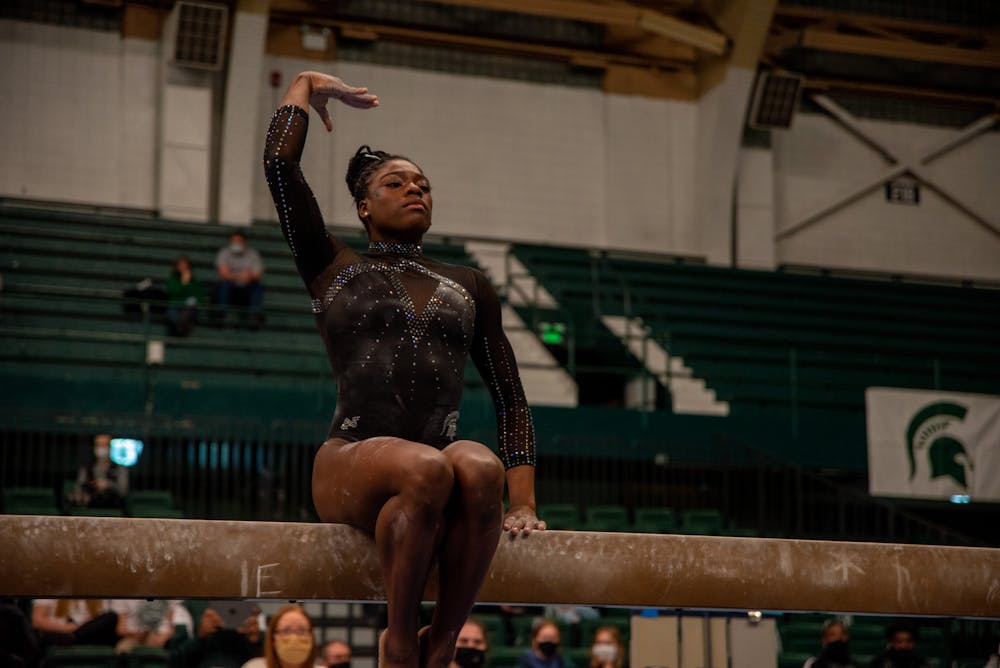 <p>An MSU gymnast performs on the balance beam in a tri-meet against Illinois State and Bowling Green on Jan. 15, 2022.</p>