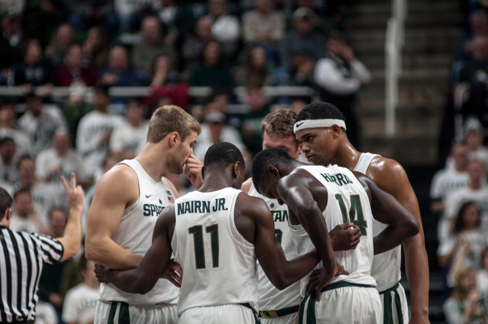 Members of the men's basketball team huddle up during a game against Florida Gulf Coast on Nov. 20, 2016 at Breslin Center. The Spartans defeated the Eagles, 78-77. 