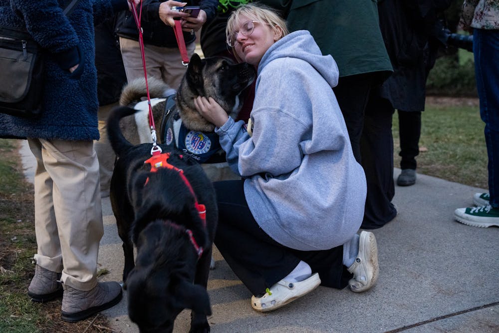 <p>ASMSU President Jo Kovach enjoys the company of Crisis Response Canine Mika on Feb. 14, 2023. Crisis Response Canines visited MSU at the Spartan Statue to provide support for students after a mass shooting took place on campus on Feb. 13, 2023. </p>