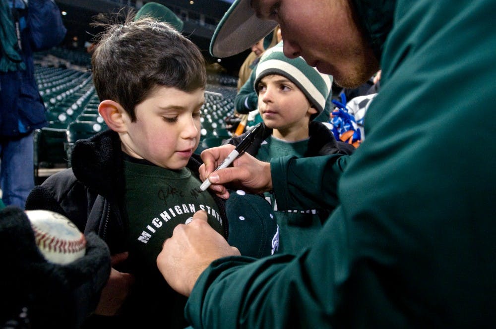 	<p>Huntington Woods-resident Ryan Serwa, 7, has his shirt signed by freshman pitcher/outfielder Jeff Kinley after the game Wednesday at Comerica Park in Detroit. Serwa cheered the Spartans to a 3-1 victory over Central Michigan. Matt Radick/The State News</p>